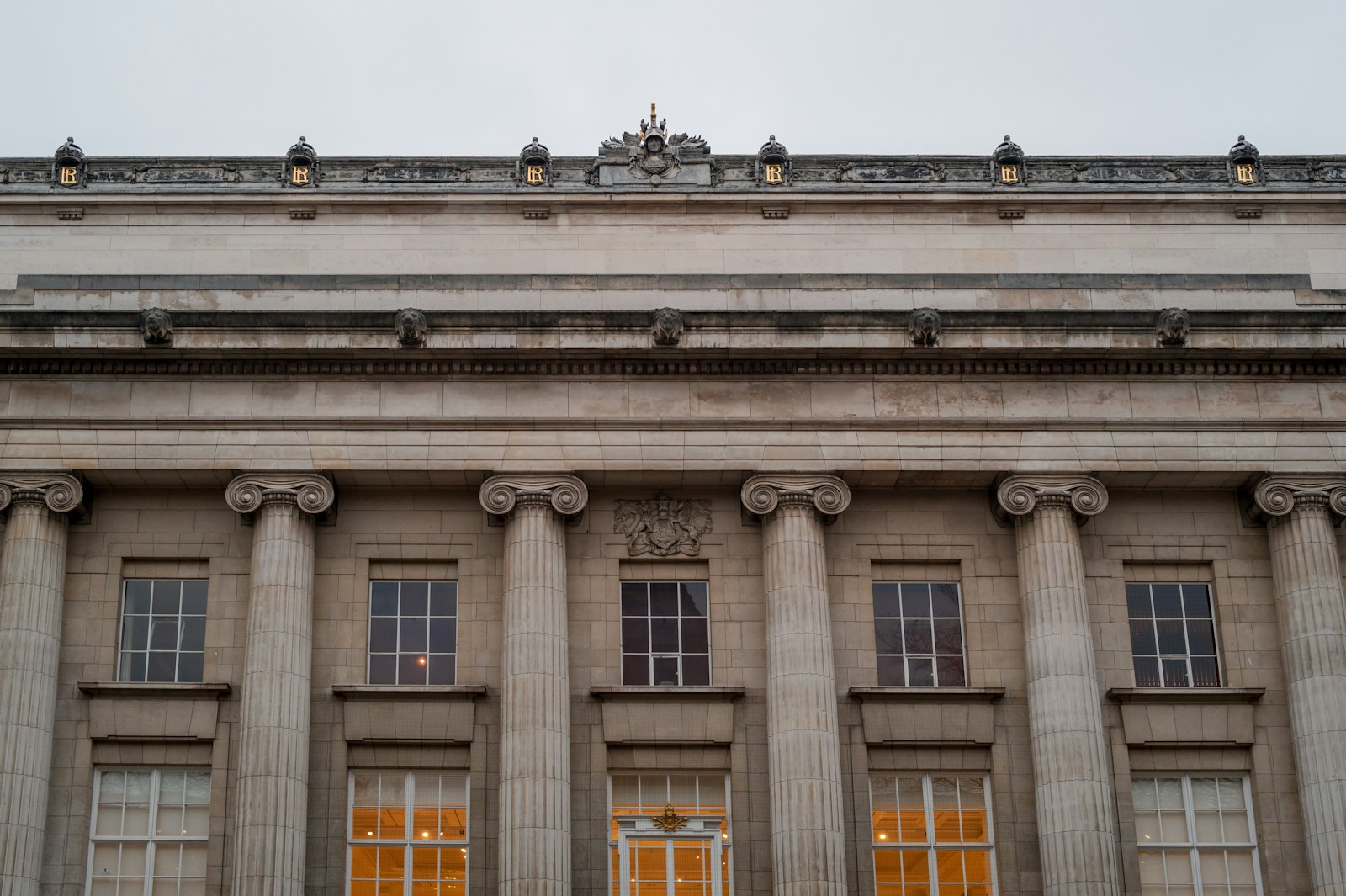 A large building with columns and a clock on top of it